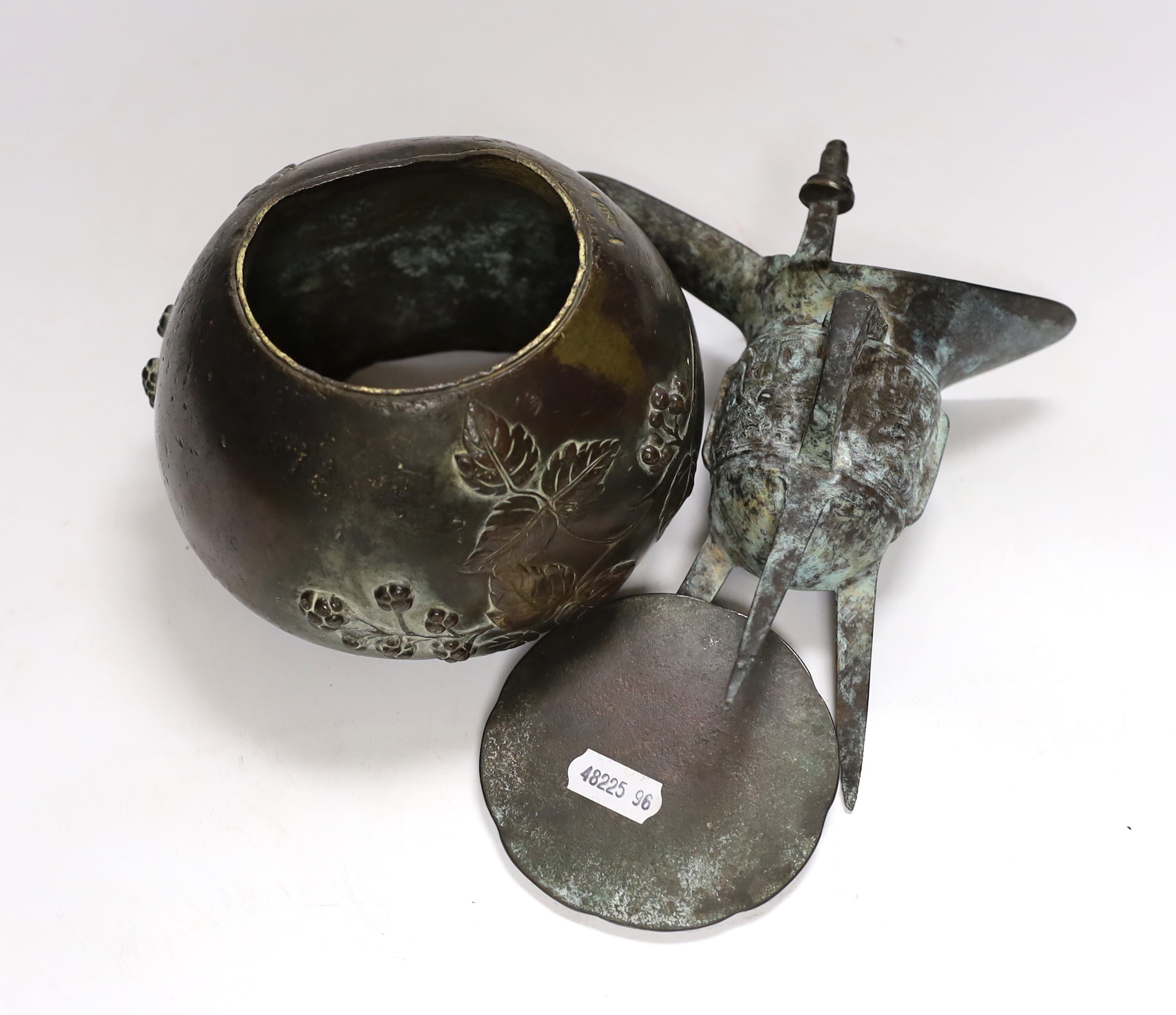 Three Chinese bronze items including a mirror back and a three footed cup, largest 18cm high